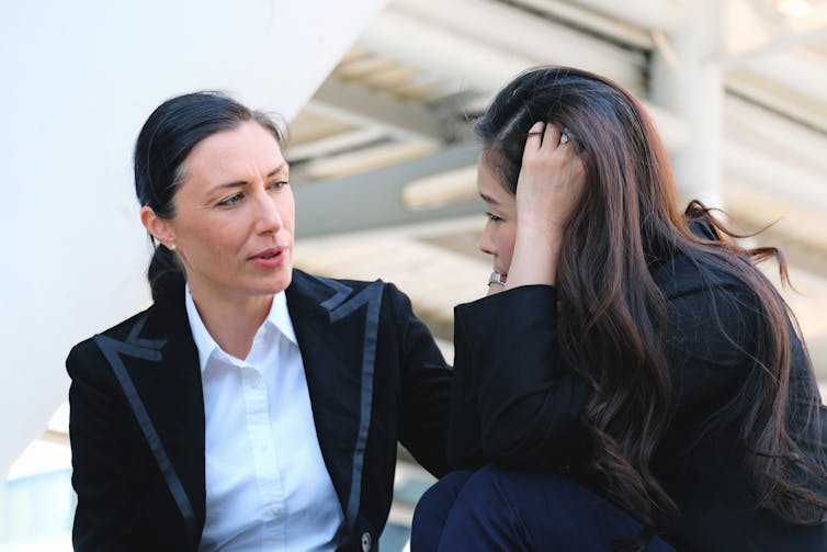 woman consoling her colleague