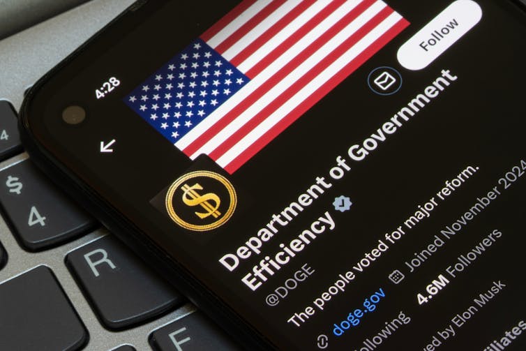 The official account of the Department of Government Efficiency (DOGE) is seen in the X app on the screen of a smartphone
