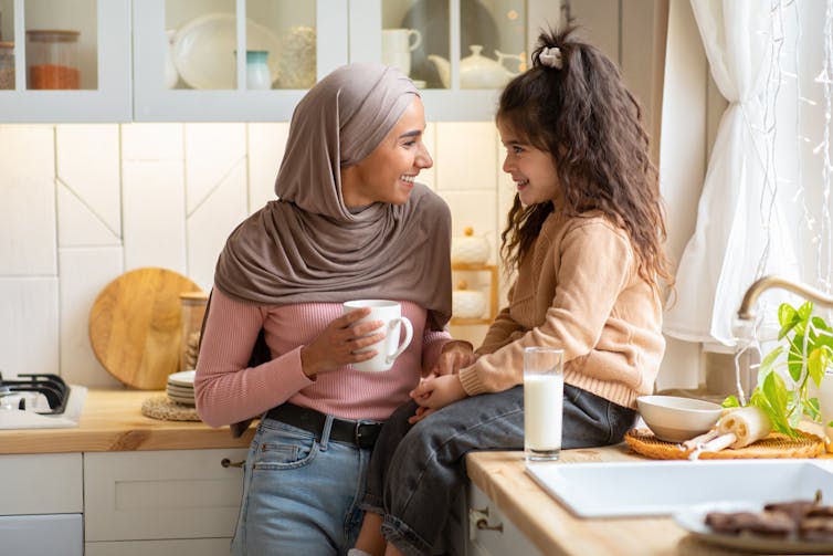 Mother and daughter talking in kitchen