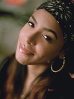 Aliyah portrait, she's wearing a bandana and hoop earrings.