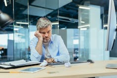Bored man at office desk
