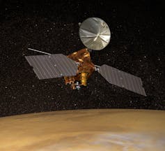 An illustration of a spacecraft with two large solar panels and a metal sheet in a circular shape orbiting around a dusty planet.