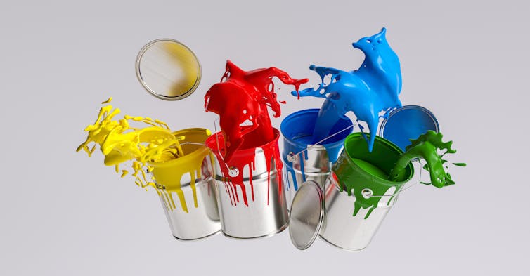 yellow red blue green pots of paint splashing, white background