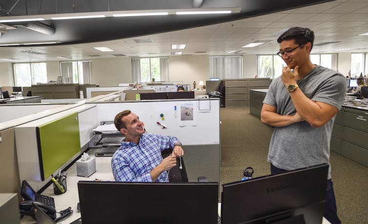 Two men have a conversation.
