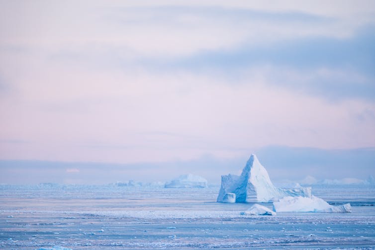A scene in Antarctica in pink and blue light.
