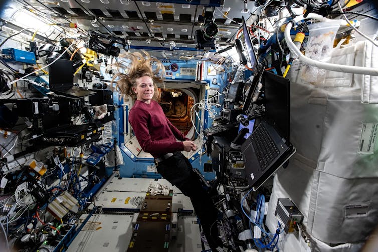 An astronaut floats weightless aboard the International Space Station.