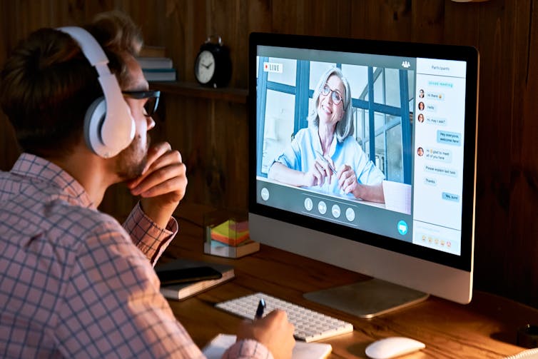 A man takes part in a video call at a desk